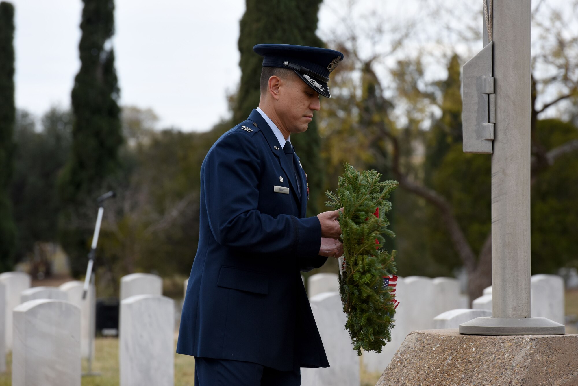 U.S. Air Force Col. Ricky Mills, 17th Training Wing commander, lays a symbolic wreath representing all those who have served in the Air Force at the Wreaths Across America ceremony, at Belvedere Memorial Park, San Angelo, Texas, Dec. 16, 2017. Mills was one of several commanders and active duty members to lay a wreath to represent their branch of service and honor all who have served. (U.S. Air Force photo by Airman 1st Class Seraiah Hines/Released)