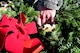 Staff Sgt. Charles Jones, 4th Logistics Readiness Squadron NCO in charge of training and mobility, hands out wreaths to be placed on the graves of fallen service members during the Wayne County Wreaths Across America ceremony Dec. 16, 2017, at Evergreen Memorial Cemetery in Princeton, North Carolina.