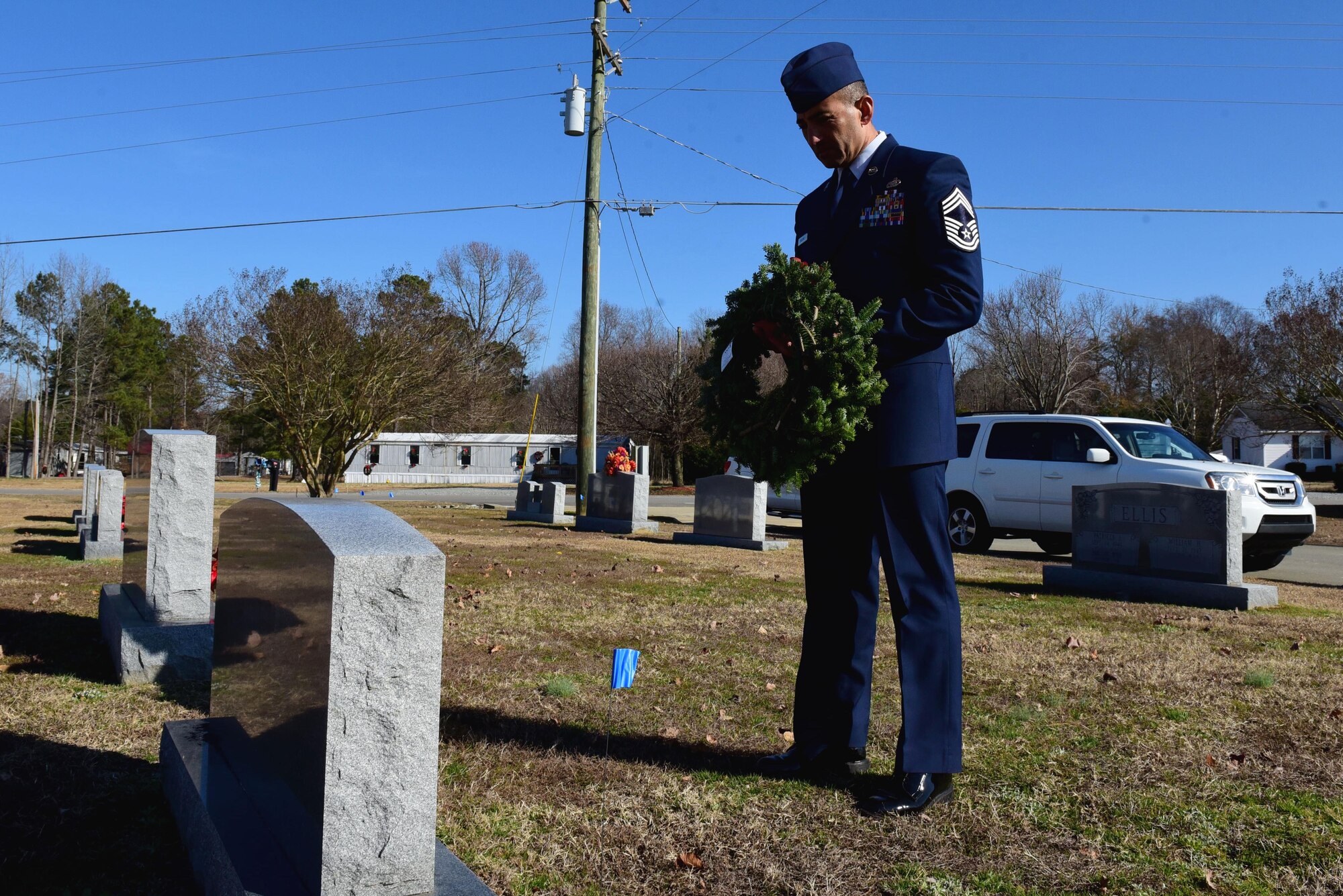 Chief Master Sgt. Marlon Carcamo, 4th Mission Support Group superintendent, lays a wreath on the grave of a fallen service member during the Wayne County Wreaths Across America ceremony Dec. 16, 2017, at Evergreen Memorial Cemetery in Princeton, North Carolina.