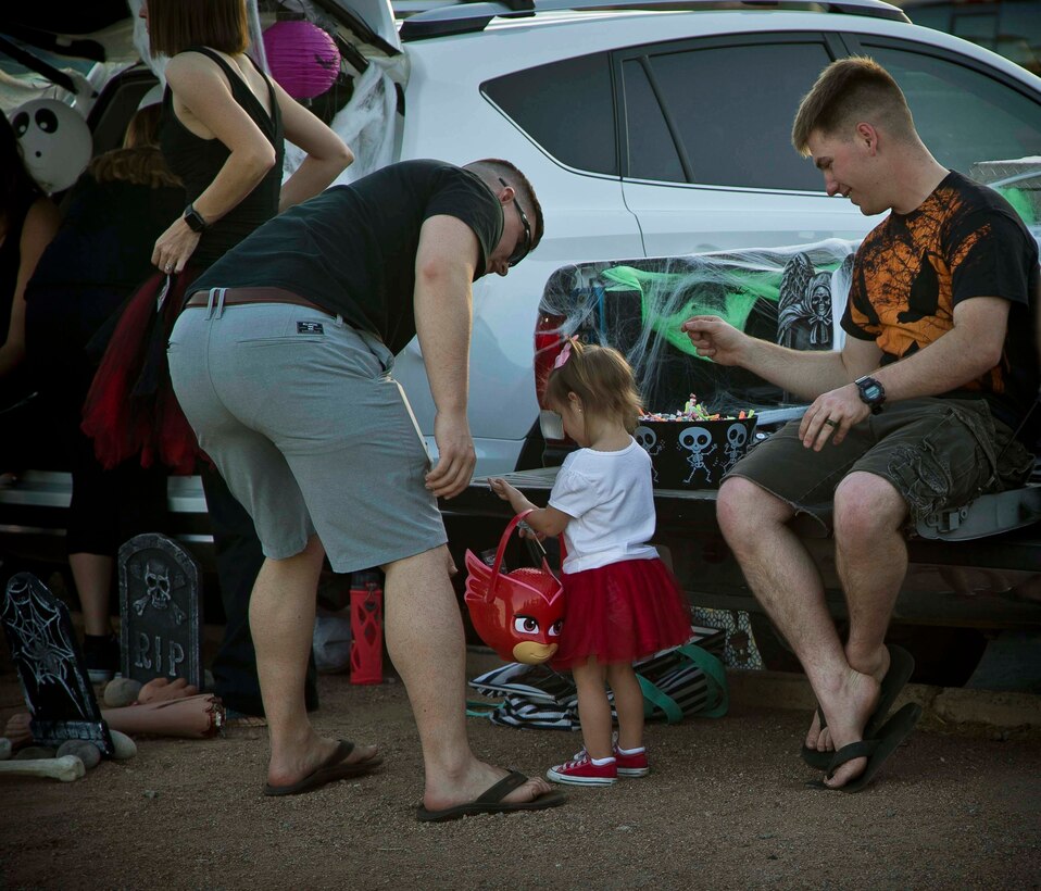 Active duty military members, DoD personnel and their families enjoy candy, games, and Halloween decorations during the third annual Trunk or Treat event held on the parade deck aboard Marine Corps Air Station Yuma, Ariz., Oct. 26, 2017. The event is a collaborative effort between the Alcohol Abuse Prevention Program, the Sexual Assault Prevention Program, the Drug Demand Reduction Program, and Marine Corps Family Team Building in honor of Red Ribbon Week. (U.S. Marine Corps photo by Lance Cpl. Joel Soriano)