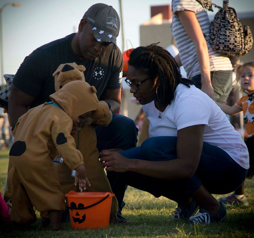 Active duty military members, DoD personnel and their families enjoy candy, games, and Halloween decorations during the third annual Trunk or Treat event held on the parade deck aboard Marine Corps Air Station Yuma, Ariz., Oct. 26, 2017. The event is a collaborative effort between the Alcohol Abuse Prevention Program, the Sexual Assault Prevention Program, the Drug Demand Reduction Program, and Marine Corps Family Team Building in honor of Red Ribbon Week. (U.S. Marine Corps photo by Lance Cpl. Joel Soriano)