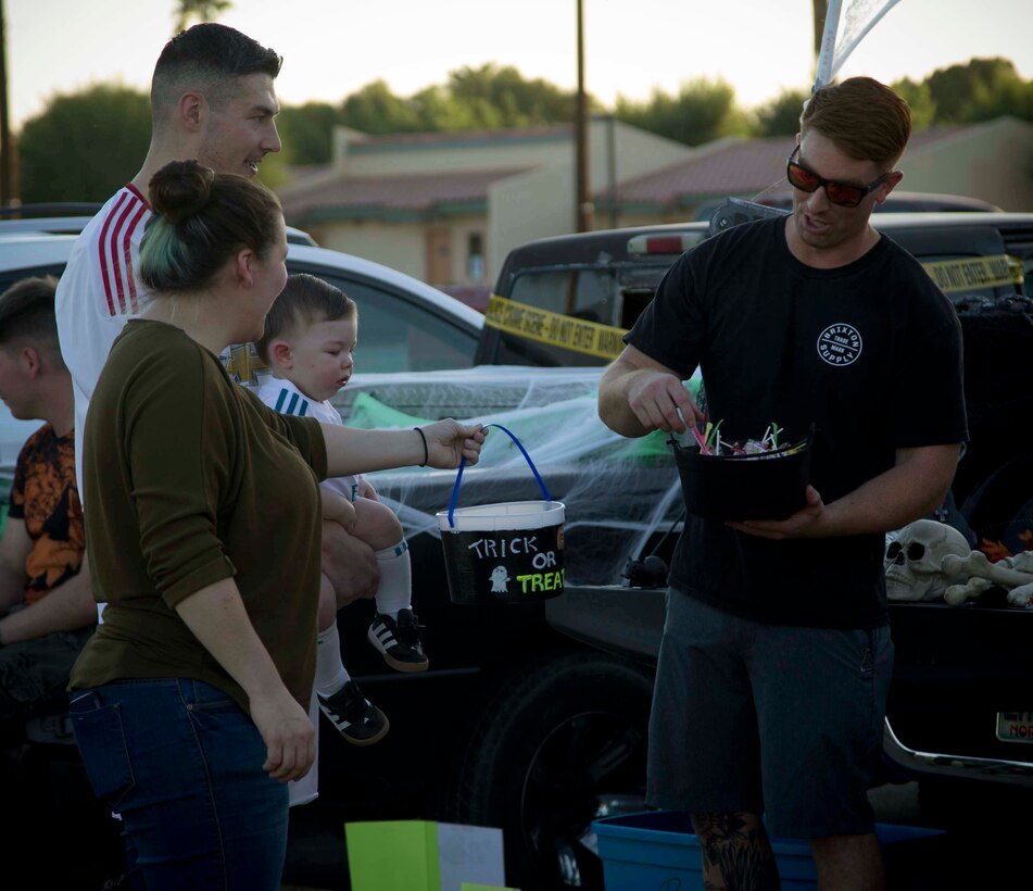 Active duty military members, DoD personnel and their families enjoy candy, games, and Halloween decorations during the third annual Trunk or Treat event held on the parade deck aboard Marine Corps Air Station Yuma, Ariz., Oct. 26, 2017. The event is a collaborative effort between the Alcohol Abuse Prevention Program, the Sexual Assault Prevention Program, the Drug Demand Reduction Program, and Marine Corps Family Team Building in honor of Red Ribbon Week. (U.S. Marine Corps photo by Lance Cpl. Joel Soriano)