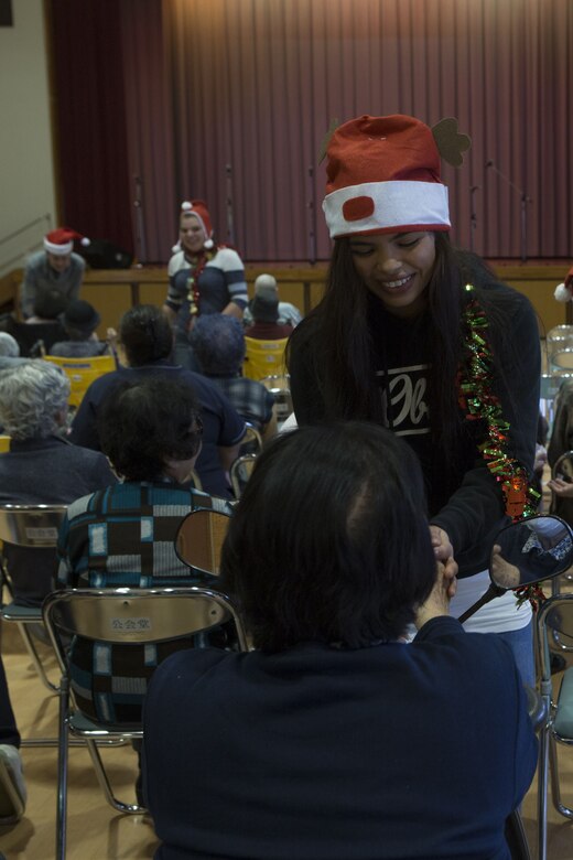 NAGO, OKINAWA, Japan— Lance Cpl. Estrella Garcia talks with an elderly woman Dec. 15 at the Okinawa Airakuen Sanatorium in Nago, Okinawa, Japan.