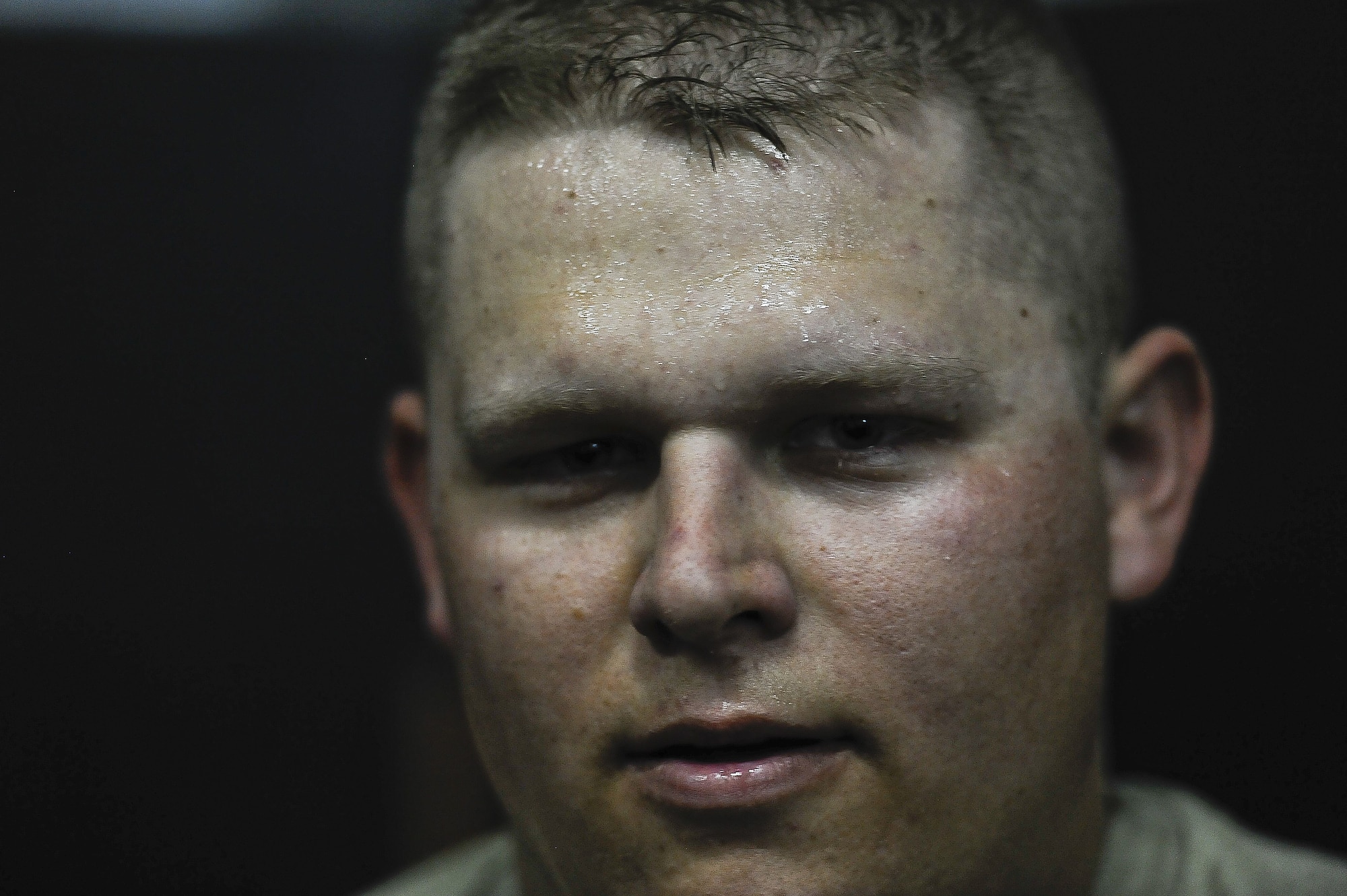 Airman 1st Class Joshua Isgitt, 380th Expeditionary Security Forces, takes a moment to gather his breathe after completing the "Redman" portion of ASP Baton training at Al Dhafra Air Base, United Arab Emirates Dec. 1, 2017. Security Forces members are responsible for the safety, personnel and assets on the installation. 

 (U.S. Air Force photo by Tech. Sgt. Anthony Nelson Jr)