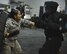 Staff Sgt. Maria Fuentes, 380th Expeditionary Security Forces, holds her baton while giving verbal instructions to 1st Lt. Michael Thrasher during ASP Baton training at Al Dhafra Air Base, United Arab Emirates Dec. 1, 2017. During this training members have the opportunity to demonstrate defense techniques using the ASP Baton against opponents dressed in redman gear. 
 (U.S. Air Force photo by Tech. Sgt. Anthony Nelson Jr)