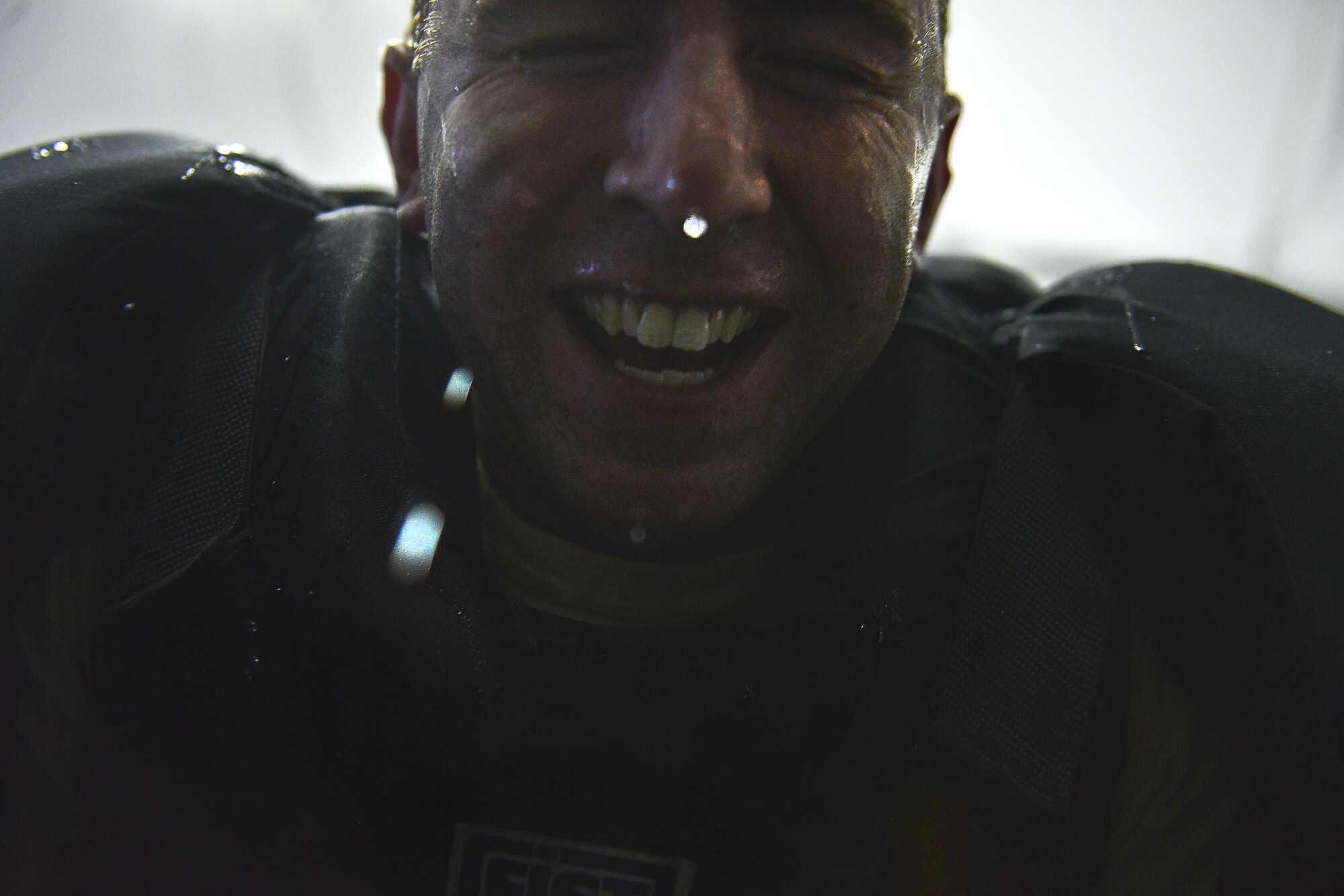 1st Lt. Michael Thrasher, 380th Expeditionary Security Forces, removes his headgear after the last Security Forces member completes the "Redman" portion of the ASP Baton training at Al Dhafra Air Base, United Arab Emirates Dec. 1, 2017. Trasher volunteered to be "Redman" during the training to evaluate the security forces members on their defense techniques and verbal commands. 
 (U.S. Air Force photo by Tech. Sgt. Anthony Nelson Jr)