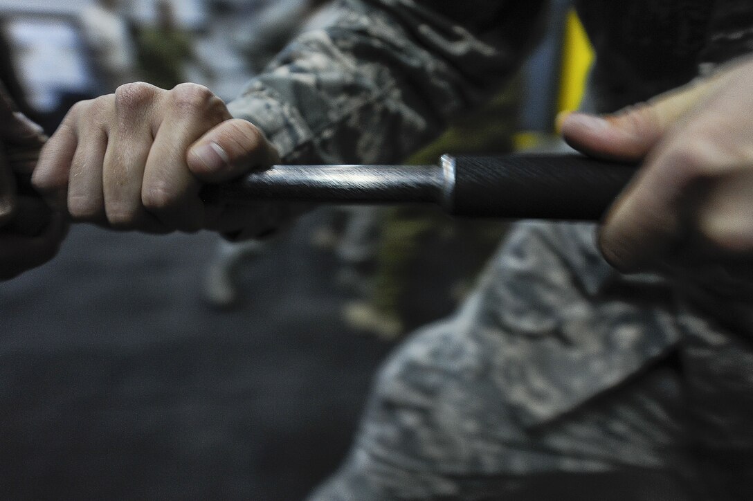 Airman 1st Class Preston Underwood, 380th Expeditionary Security Forces Squadron, performs a tactical move against a fellow Security Forces member during ASP Baton training at Al Dhafra Air Base, United Arab Emirates Dec. 1, 2017. Security Forces members use this training to keep current on their skills and techniques. 
 (U.S. Air Force photo by Tech. Sgt. Anthony Nelson Jr)