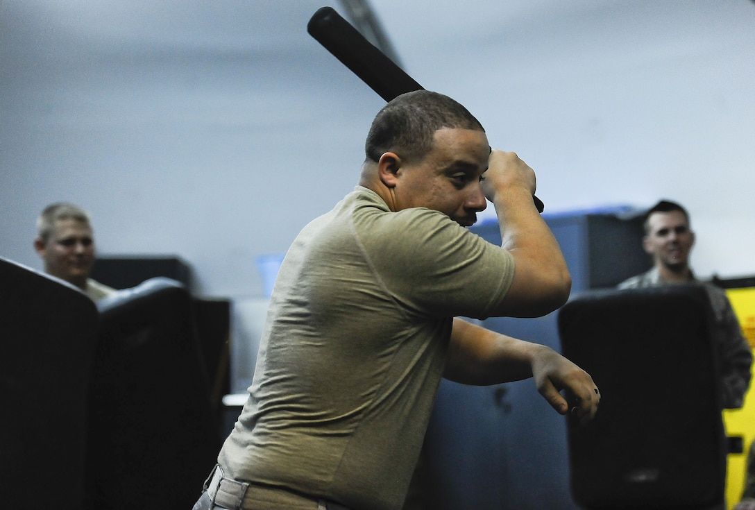 Senior Airman, Michael Ortiz, 380th Expeditionary Security Forces Squadron, demonstrates ASP baton tactical techniques before the "Redman" portion of ASP Baton training at Al Dhafra Air Base, United Arab Emirates Dec. 1, 2017. Security Forces members are responsible for the safety, personnel and assets on the installation. 
 (U.S. Air Force photo by Tech. Sgt. Anthony Nelson Jr)