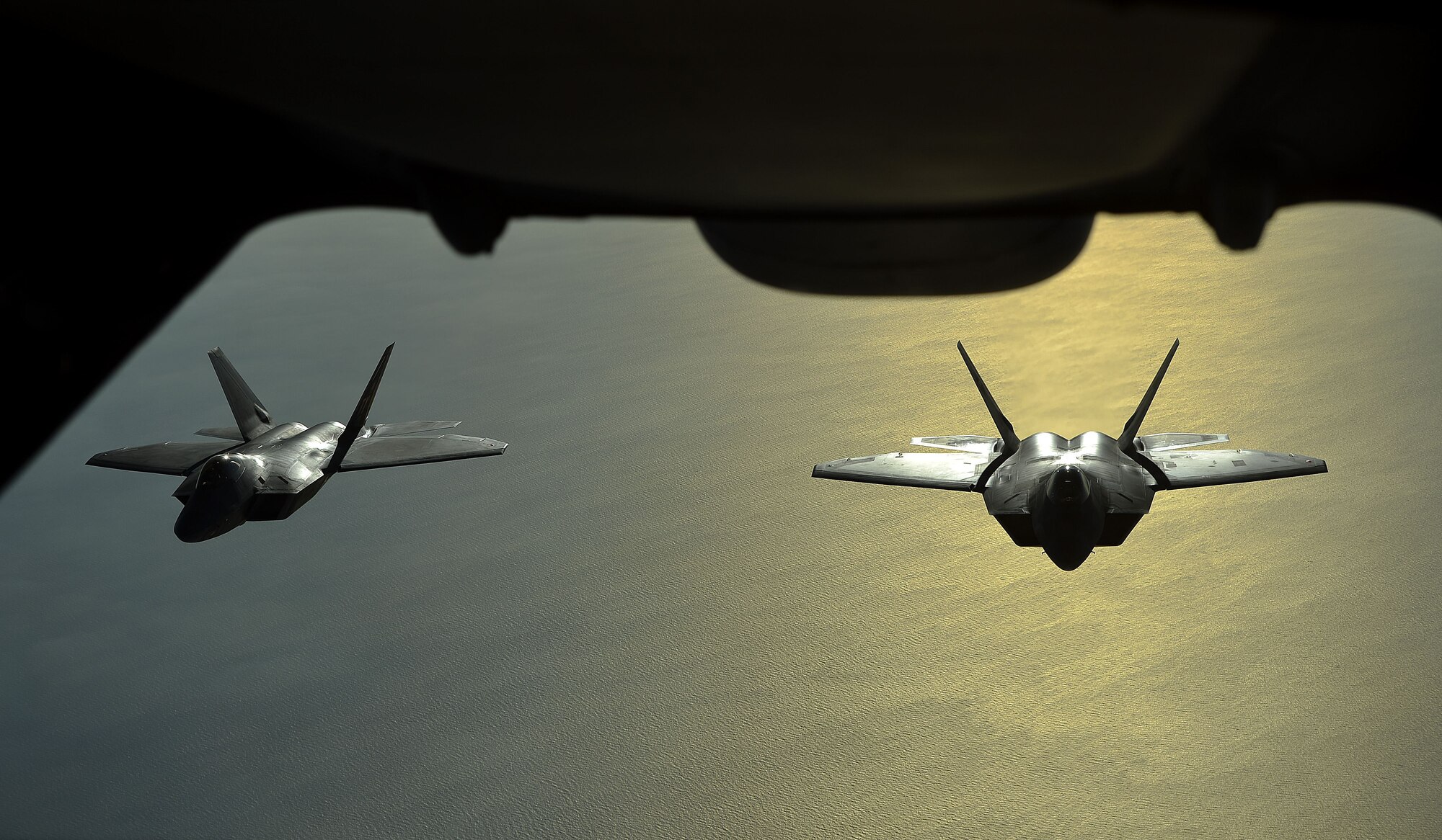 Two F-22's assigned to the 380th Air Expeditionary Wing, Al Dhafra Air Base, United Arab Emirates fly over the Arabian Peninsula Nov. 29, 2017. The F-22 is a component of the Global Strike Task Force, supporting U.S. and Coalition forces working to liberate territory and people under the control of ISIS. 

 (U.S. Air Force photo by Tech. Sgt. Anthony Nelson Jr.)