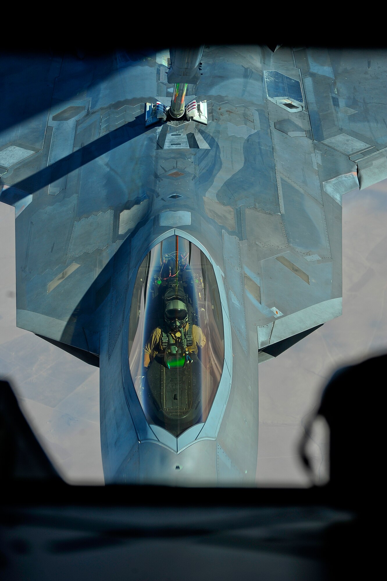 An F-22 Pilot assigned to the 380th Air Expeditionary Wing, Al Dhafra Air Base, United Arab Emirates receives fuel over Iraq from a KC-10 Extender, Nov. 29, 2017. The F-22 performs both air-to-air and air-to-ground missions. 

 (U.S. Air Force photo by Tech. Sgt. Anthony Nelson Jr.)