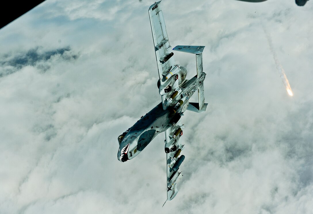 An U.S. Air Force A-10 Thunderbolt II pilot, currently assigned to the 332nd Air Expeditionary Wing, shoots flares off after receiving fuel from a 908th Expeditionary Air Refueling Squadron KC-10 Extender Nov. 29, 2017. The A-10 can employ a wide variety of conventional munitions, including general purpose bombs, cluster bomb units, laser guided bombs, joint direct attack munitions and more. 
 (U.S. Air Force photo by Tech. Sgt. Anthony Nelson Jr.)