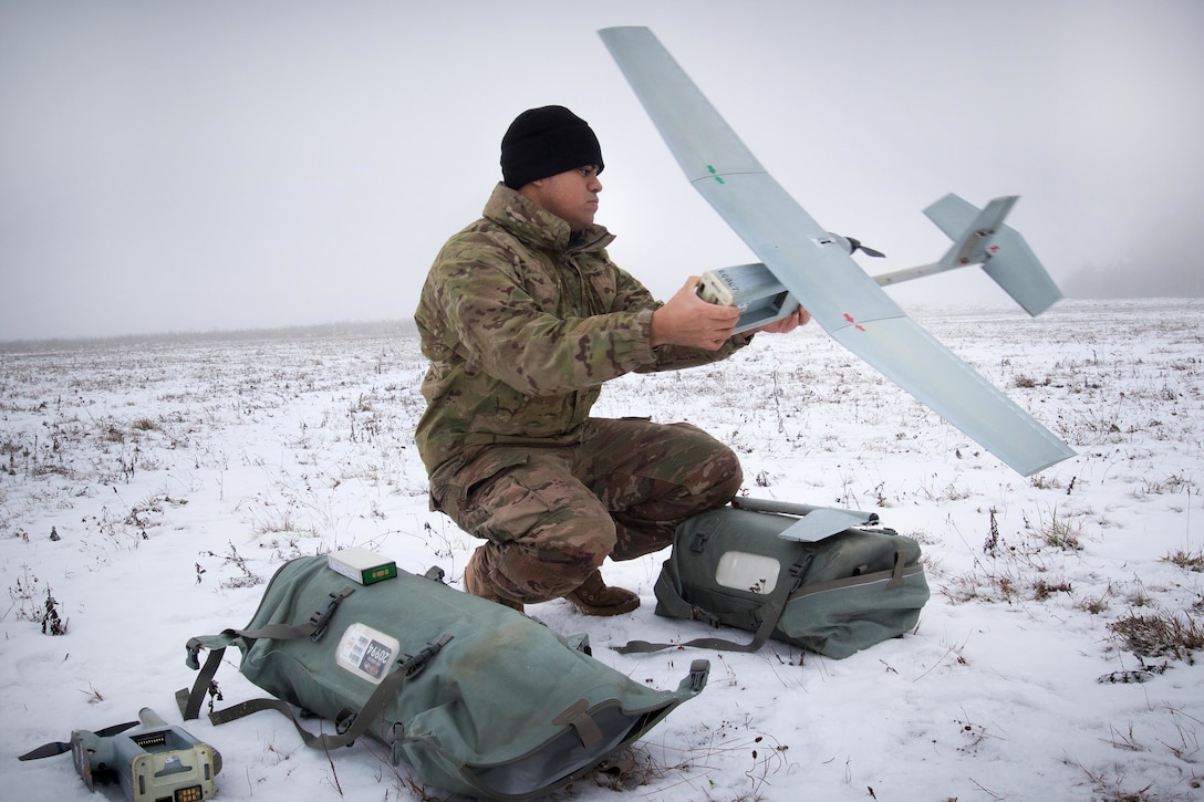 Army Sgt. Jorge Maturino trouble shoots issues while preparing a Raven Unmanned Aerial Vehicle for training.