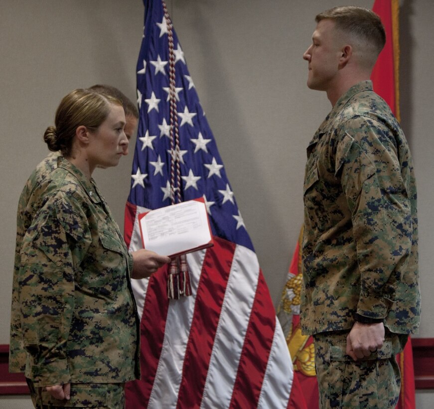 Marine Corps Lt. Col. Taunja M. Menke, left, commanding officer of the Ground Supply School, Marine Corps Combat Service Support Schools awards 2nd Lt. Spencer Preston, right, a student attending the Ground Supply Officer Course with the Navy and Marine Corps Achievement Medal at Camp Johnson, N.C., Dec. 8, 2017. Preston was recognized for rescuing a fellow Marine involved in a motorcycle accident. Marine Corps photo by Lance Cpl. Tyler Pender