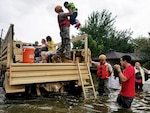 Members of the Texas National Guard in Houston  rescue stranded residents in flooded areas from the storms of Hurricane Harvey.