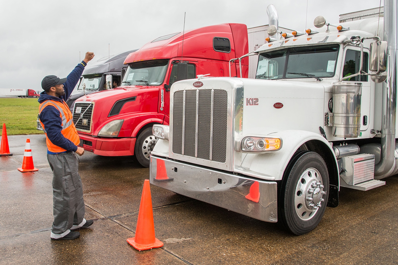 A Defense Logistics Agency employee lines up a row of tractor trailers on Maxwell Air Force Base, Alabama, preparing to depart for Florida. Maxwell housed more than 800 trailers laden with relief supplies destined for Florida after Hurricane Irma left the state.