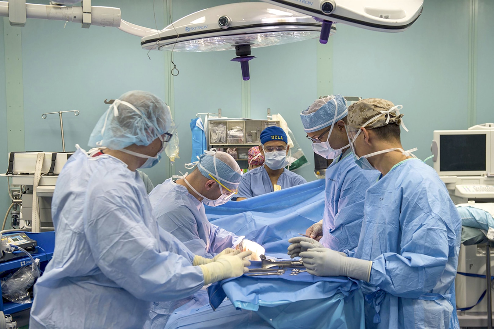 Sailors perform a surgical operation in an operating room aboard the hospital ship USNS Comfort in the Caribbean Sea. The Comfort is providing medical services to people affected by Hurricane Maria, with supply support from DLA.