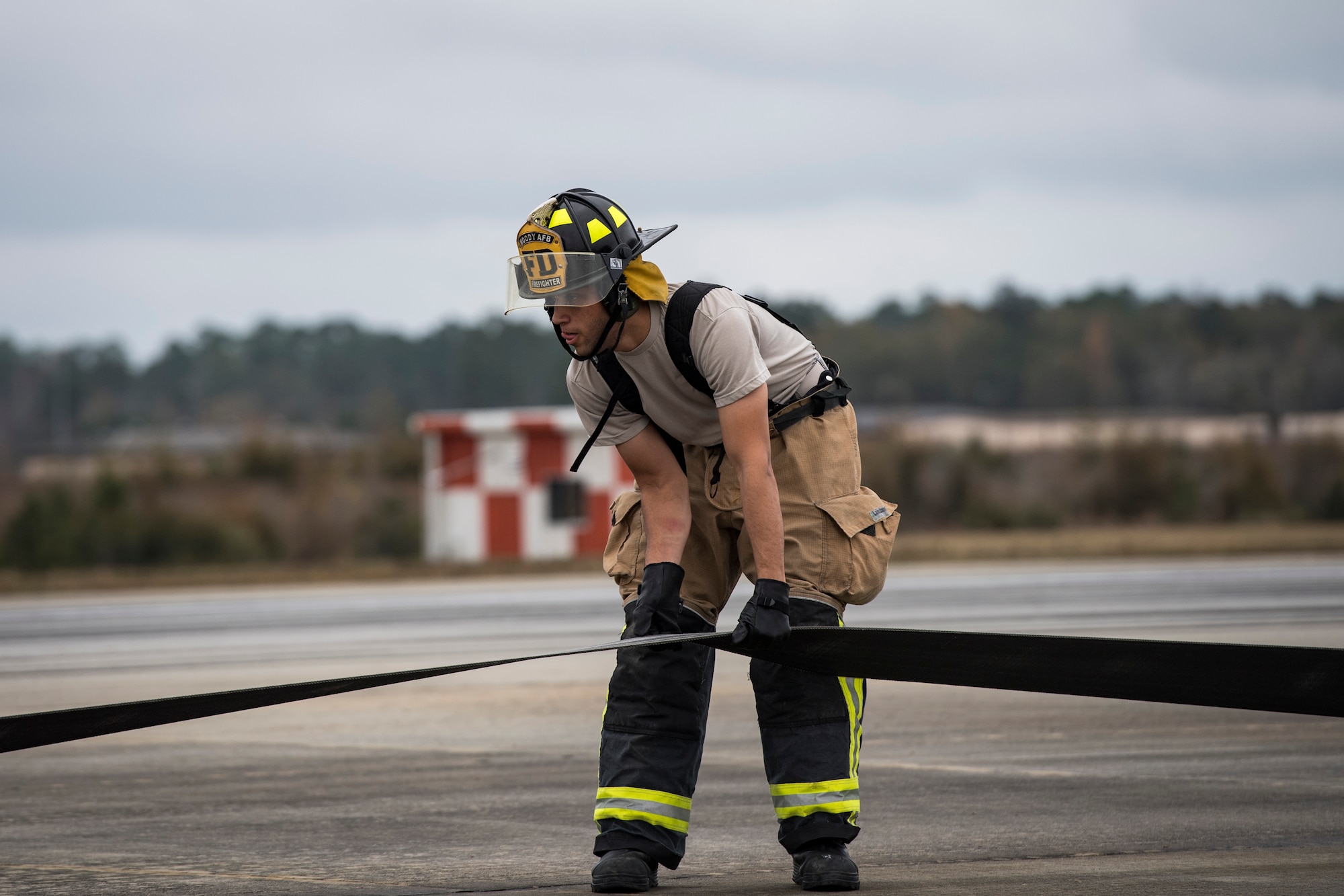 An Airman from the 23d Civil Engineer Squadron fire department prepares a cable to release an F-15C Eagle from an arresting system, Dec. 19, 2017, at Moody Air Force Base, Ga. The BAK-12 arresting system that is used on the runway to slow down fighter aircraft in emergency situations. The $250,000 system will now be completely replaced every 10 years. (U.S. Air Force photo by Senior Airman Janiqua P. Robinson)
