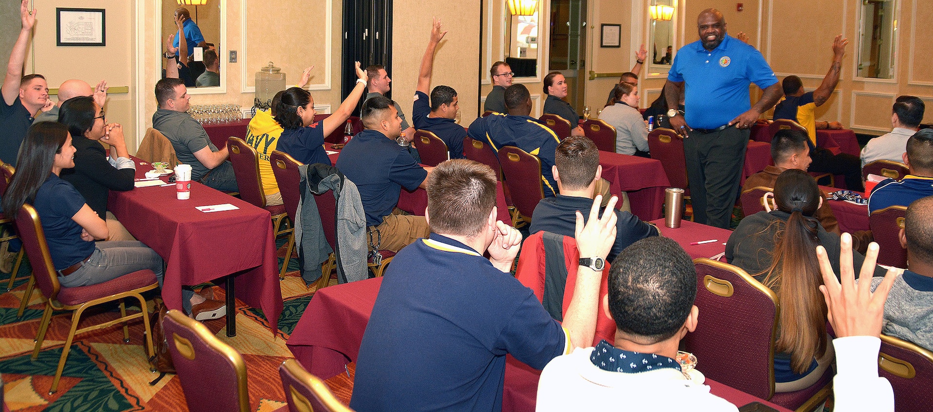 Navy veteran Michael Lindsey, a facilitator assigned to the Navy’s 21st Century Sailor office in Norfolk, Va., speaks with second class petty officers of Navy Recruiting District San Antonio about operational stress control during a district training meeting held at the Crowne Plaza Hotel in Austin Dec. 19. More than 250 recruiters, support personnel and their spouses attended the training where they were provided with support networks, programs, resources, training, and skills needed to overcome adversity and thrive.