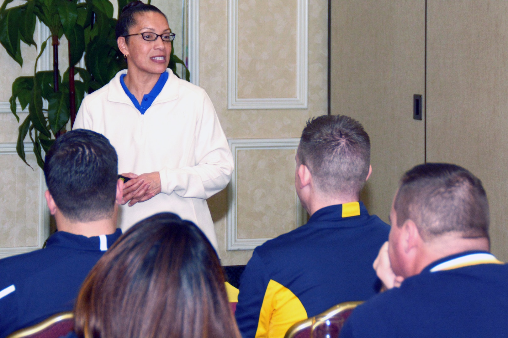 Navy veteran Martha Lara, a facilitator assigned to the Navy’s 21st Century Sailor office in Norfolk, Va., speaks with officers and chief petty officers of Navy Recruiting District San Antonio about Operational Stress Control during a district training meeting held at the Crowne Plaza Hotel in Austin Dec. 19. More than 250 recruiters, support personnel and their spouses attended the training where they were provided with support networks, programs, resources, training, and skills needed to overcome adversity and thrive.