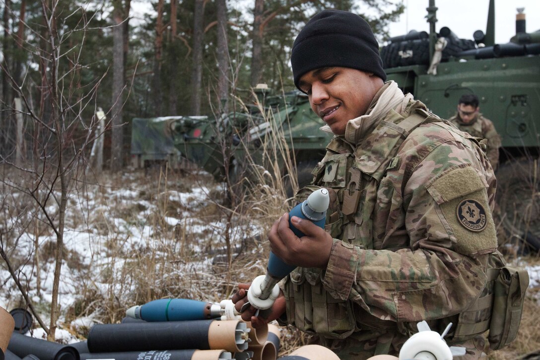 Army Spc. Deonte Rickman prepares ammunition for his team’s 81-millimeter mortar.