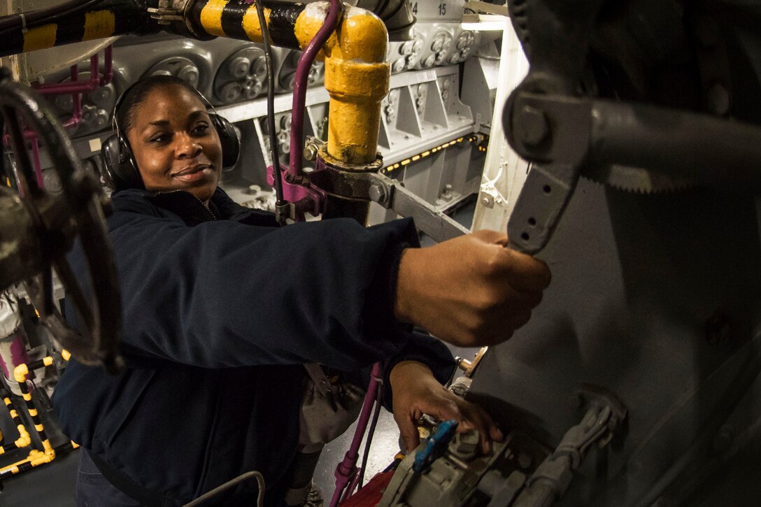 A sailor operates an emergency diesel generator operations.