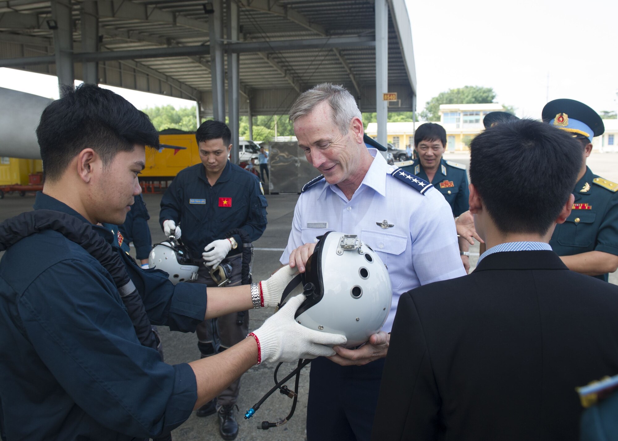 Gen. Terrence J. O’Shaughnessy, Pacific Air Forces commander, inspects a Vietnamese Air Defense-Air Force (ADAF) pilot’s helmet, during a visit to Bien Hoa Air Base, Vietnam, Dec. 16.