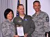 Col. Janette Thode, 340th FTG commander, and superintendent Chief Master Sgt. Jimmie Morris present the Air Force Reserve Command Gen. Mark Welsh One Air Force and Chief of Staff Team Excellence awards went to Undergraduate Flying Training program manager Lt. Col. Timothy Chapman during the December 2017 mandatory unit training assembly. (U.S. Air Force photo)