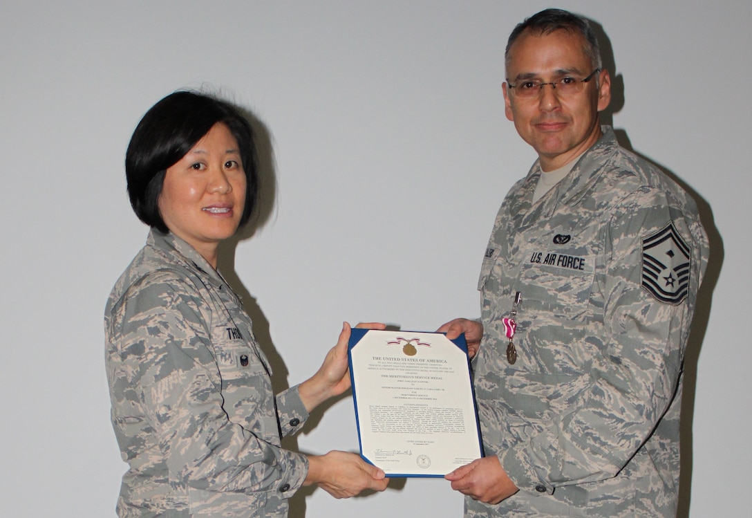 Col Janette Thode, 340th Flying Training Group commander, presents the Meritorious Service Medal to 340th FTG improvement process manager Senior Master Sgt. Samuel Caballero during the December 2017 mandatory unit training assembly. (U.S. Air Force photo)