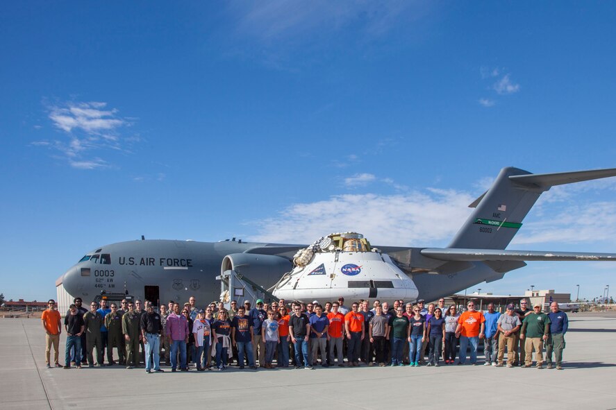 The Orion spacecraft Capsule Parachute Assembly System team pose for a photo before the mockup spacecraft is loaded onto a C-17 Globemaster III, Dec. 11, in Yuma, Arizona. (U.S. Air Force photo by Christopher A. Okula)