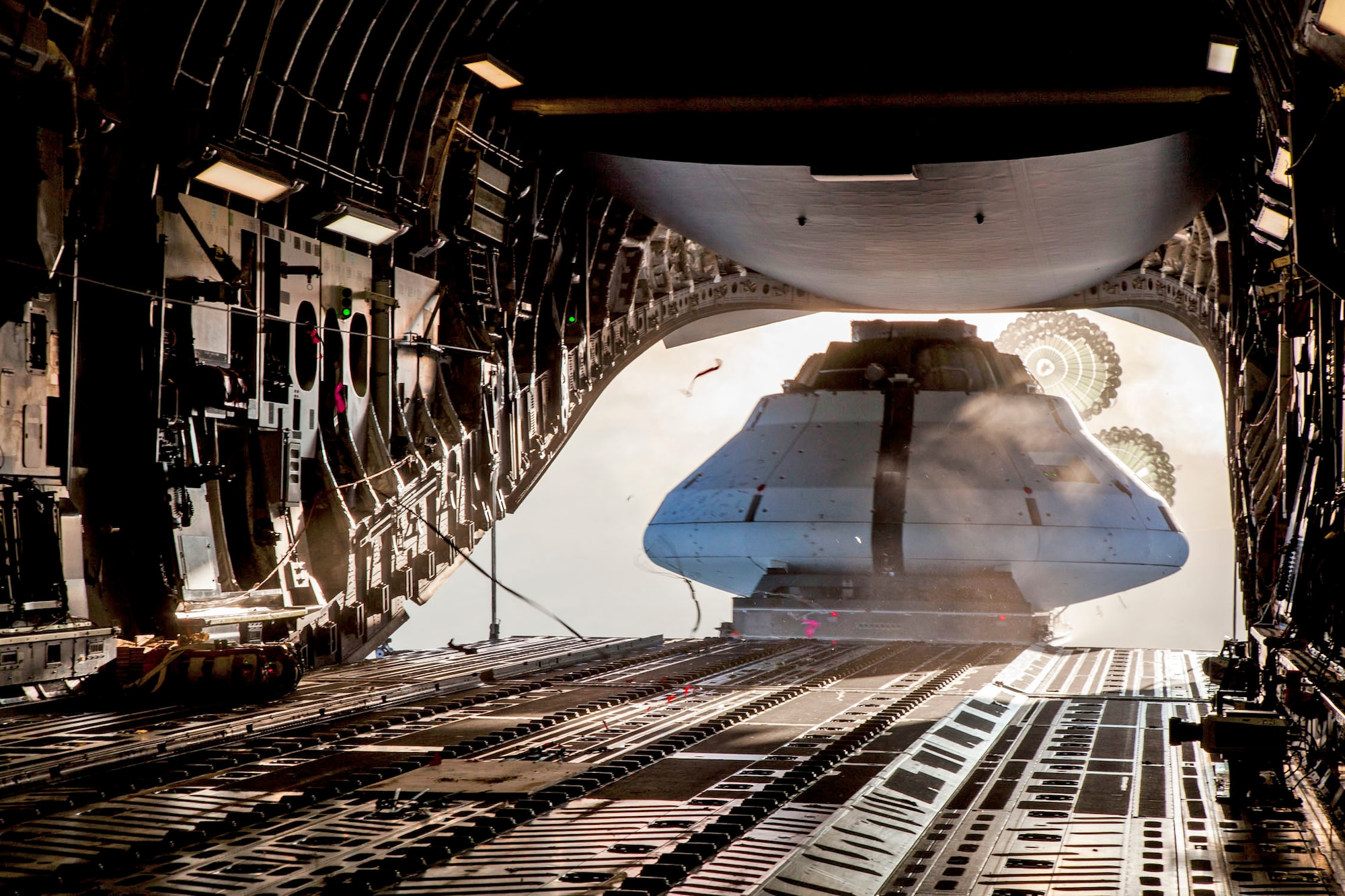 The Orion spacecraft Capsule Parachute Assembly System team pose for a photo before the mockup spacecraft is loaded onto a C-17 Globemaster III, Dec. 11, in Yuma, Arizona. (U.S. Air Force photo by Christopher A. Okula)