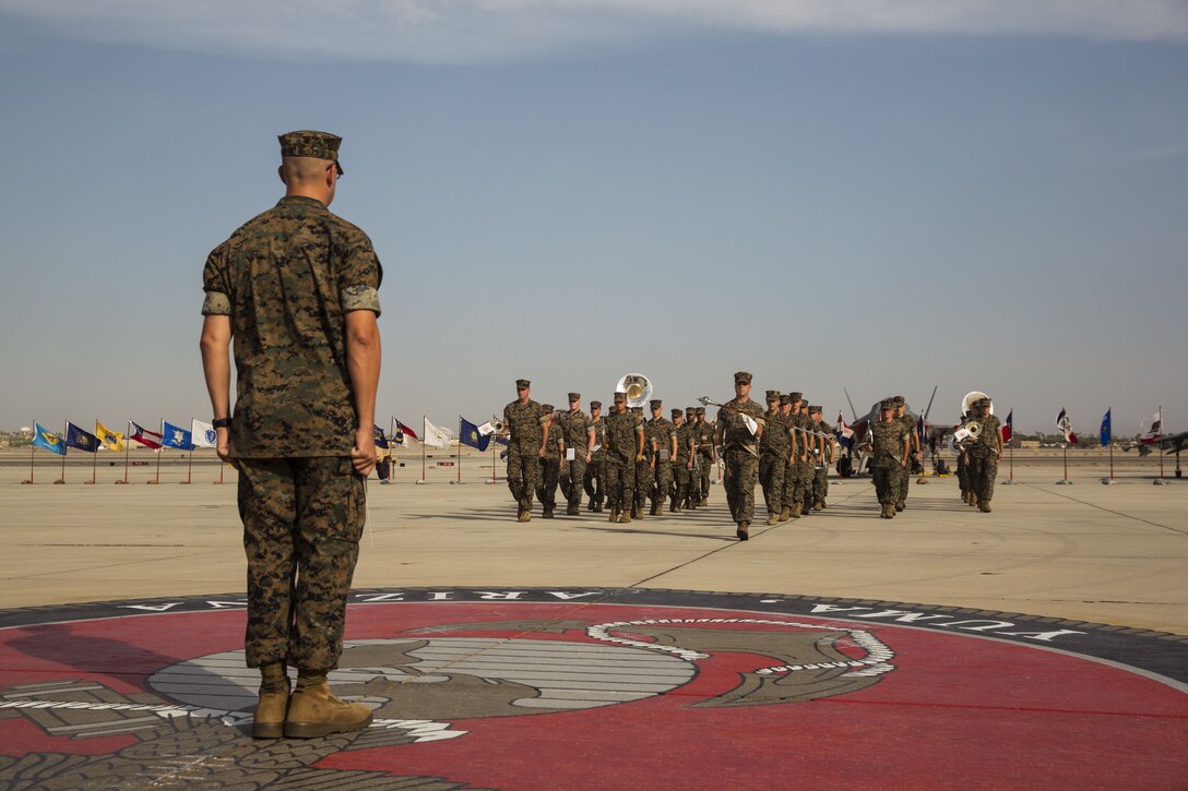 U.S. Marines assigned to the 3rd Marine Aircraft Wing Band perform during the Marine Aircraft Group (MAG) 13 change of command ceremony on the flightline at Marine Corps Air Station Yuma, Ariz., July 28, 2017. Col. Marcus B. Annibale, the outgoing commanding officer of MAG-13, relinquished command to the oncoming commanding officer, Col. William R. Sauerland. (U.S. Marine Corps photo taken by Lance Cpl. Christian Cachola)