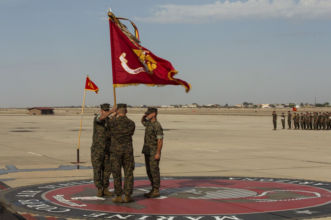 U.S. Marine Corps Col. Marcus B. Annibale (middle), the outgoing commanding officer of Marine Aircraft Group (MAG) 13, passes the colors to the oncoming commanding officer, Col. William R. Sauerland (left) during the MAG-13 change of command ceremony on the flightline at Marine Corps Air Station Yuma, Ariz., July 28, 2017. (U.S. Marine Corps photo taken by Lance Cpl. Christian Cachola)