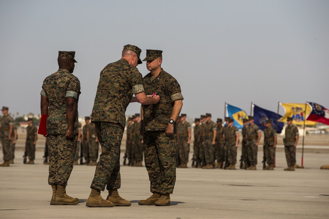 U.S. Marine Corps Col. Marcus B. Annibale, the outgoing commanding officer of Marine Aircraft Group (MAG) 13, is awarded the Legion of Merit during the MAG-13 change of command ceremony on the flightline at Marine Corps Air Station Yuma, Ariz., July 28, 2017. Col. Annibale relinquished command to the incoming commanding officer, Col. William R. Sauerland. (U.S. Marine Corps photo taken by Lance Cpl. Christian Cachola)