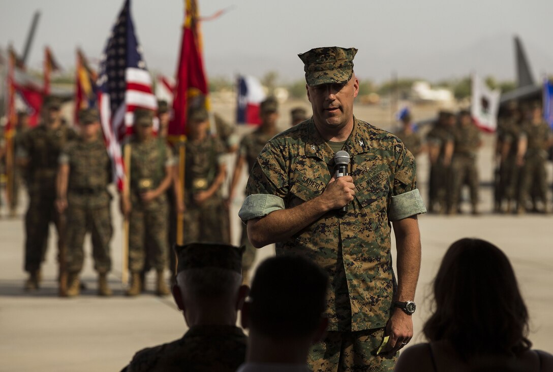 U.S. Marine Corps Col. William R. Sauerland, the oncoming commanding officer of Marine Aircraft Group (MAG) 13, addresses the crowd, Marines, family members and friends, and bids farewell to Col. Marcus B. Annibale, the outgoing commanding officer of MAG-13, and his family during the MAG-13 change of command ceremony on the flightline at Marine Corps Air Station Yuma, Ariz., July 28, 2017. (U.S. Marine Corps photo taken by Lance Cpl. Christian Cachola)