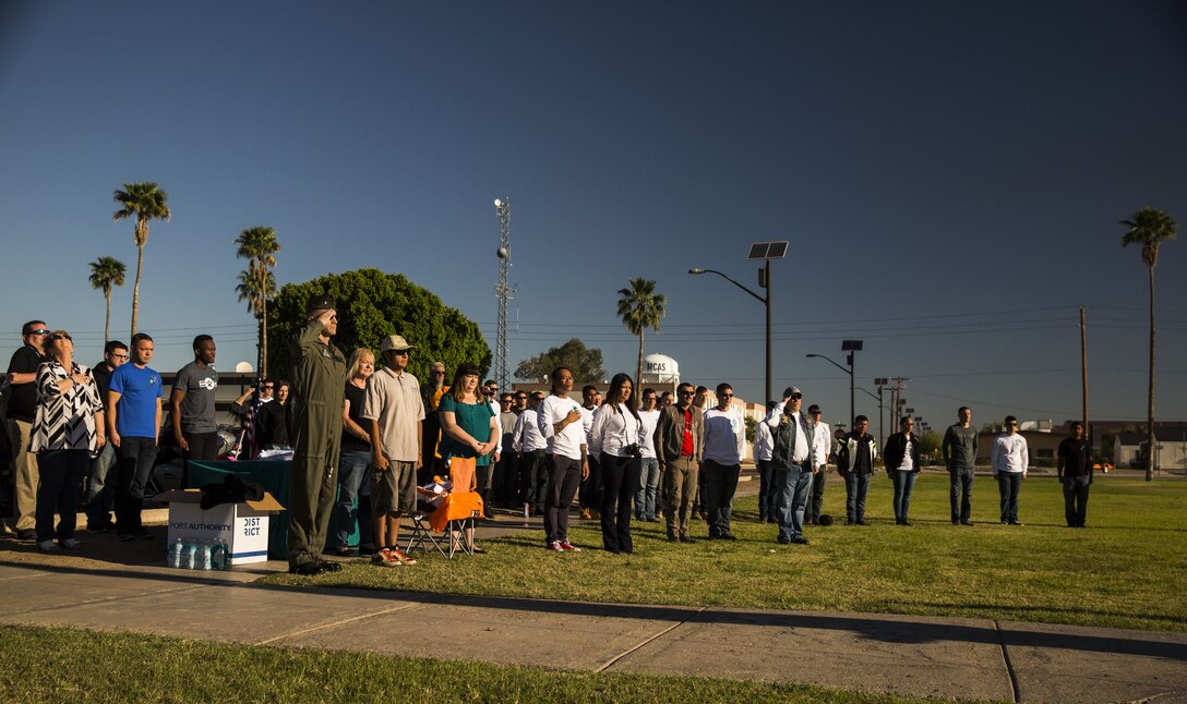 Service members, veterans, retirees and local law enforcement personnel observe morning colors during the 5th Annual Sexual Assault Awareness and Response Motorcycle Ride at Marine Corps Air Station Yuma, Ariz., Thursday, April 6, 2017. The motorcycle ride promotes Sexual Assault Awareness Month, raises awareness of the Sexual Assault Prevention and Response (SAPR) Program, and its resources available at MCAS Yuma. The event also supports Amberly’s Place, an organization that provides services to victims and their families. (U.S. Marine Corps photo taken by Lance Cpl. Christian Cachola)