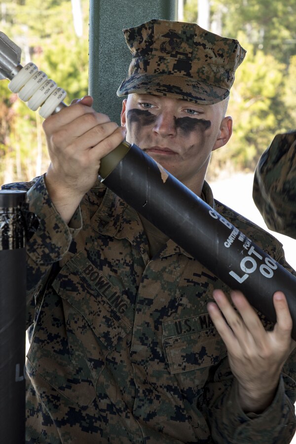 Lance Cpl. Bailey Bowling, a M224 60mm mortar system gunner, inspects a mortar round prior to conducting a live-fire mortar range at Camp Lejeune, N.C., Dec. 19, 2017. The training provided Marines with India Company, 3rd Battalion, 6th Marine Regiment, 2nd Marine Division the opportunity to increase their proficiency and familiarization with the weapon system. (U.S. Marine Corps photo by Cpl. Aaron Henson)