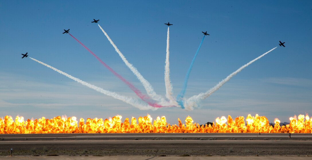 The Patriot Jet Team breaks out of formation over a "Wall Of Fire" as part of the closing act of the 2017 Yuma Airshow at Marine Corps Air Station Yuma, Ariz., Saturday, March 18, 2017. (U.S. Marine Corps photo taken by Sgt. Travis Gershaneck)