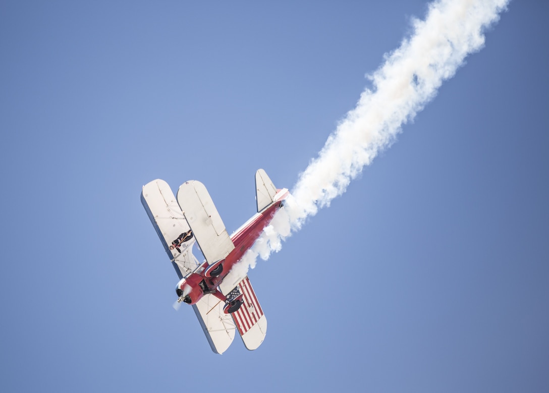 Greg Shelton, a 450 Super Stearman pilot, performs wing-walking manuevers with his wife attached to the aircraft during the 2017 Yuma Airshow at Marine Corps Air Station Yuma, Ariz., Saturday, March 18, 2017. (U.S. Marine Corps photo taken by Sgt. Summer Romero)