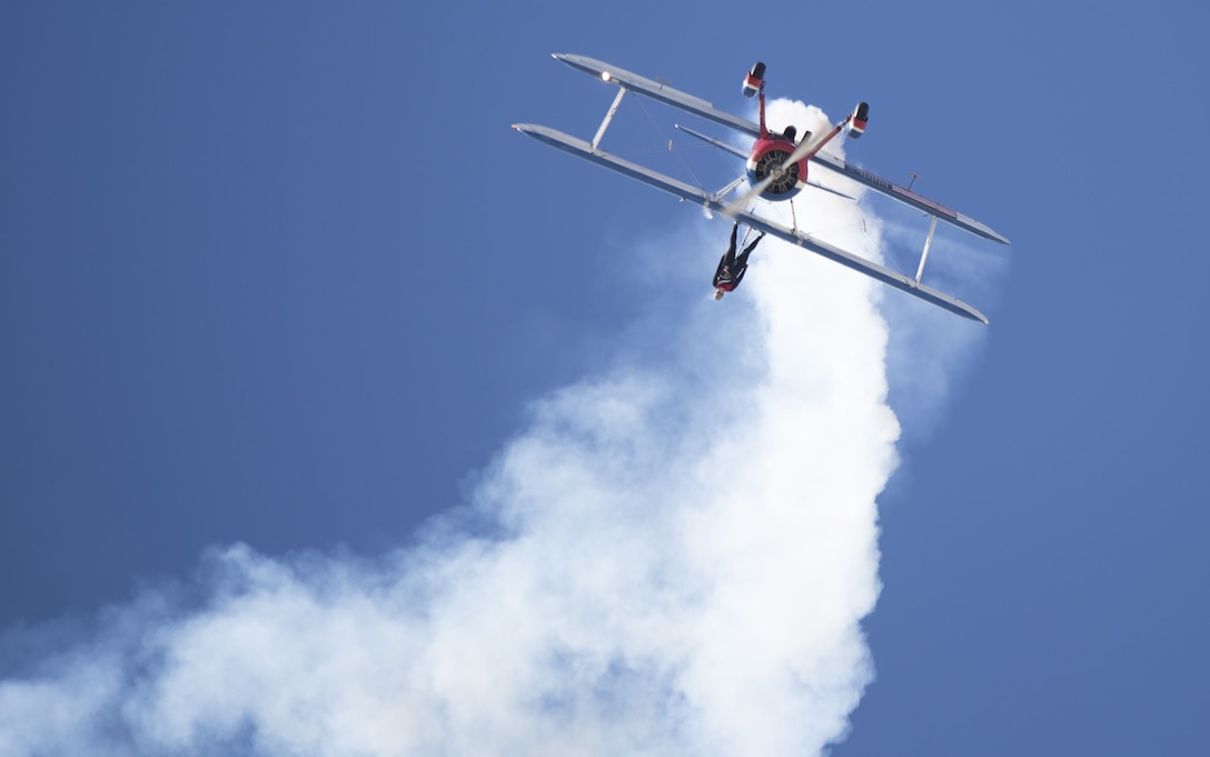 Greg Shelton, a 450 Super Stearman pilot, performs wing-walking manuevers with his wife attached to the aircraft during the 2017 Yuma Airshow at Marine Corps Air Station Yuma, Ariz., Saturday, March 18, 2017. (U.S. Marine Corps photo taken by Sgt. Summer Romero)