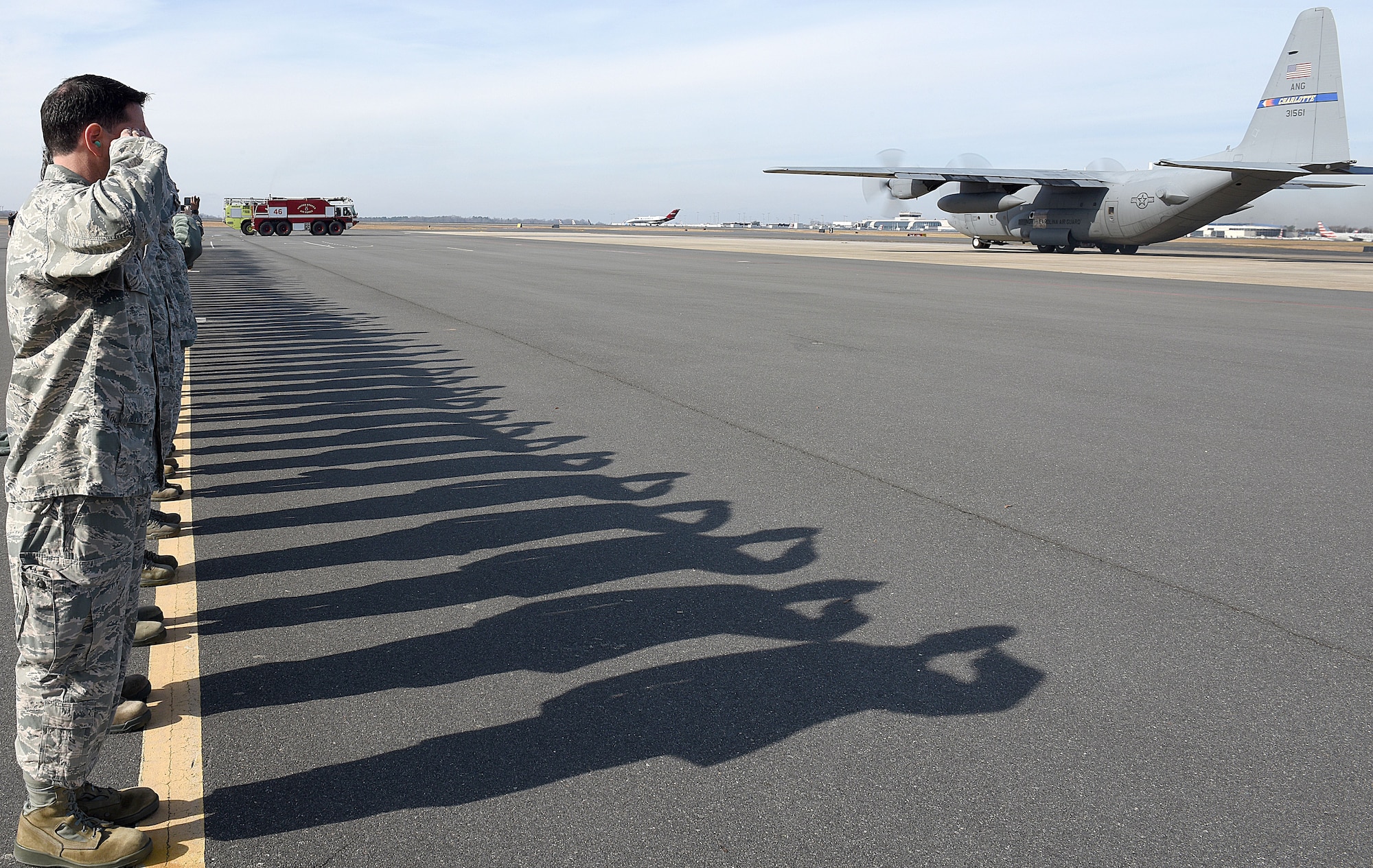 U.S. Air Force Commander for the 145th Airlift Wing, Col. Troy Gerock, leads a salute with men and women of the North Carolina Air National Guard as the last C-130 Hercules aircraft attached to the North Carolina Air National Guard Base, Charlotte Douglas International Airport departs for a new assignment at the 165th Airlift Wing in Savannah, Georgia, Dec. 18, 2017. The NCANG is in transition from flying the C-130 Hercules to C-17 Globemaster III aircraft. The change in mission will require not only a transition in aircraft and personnel, but an increase in structures throughout the base.