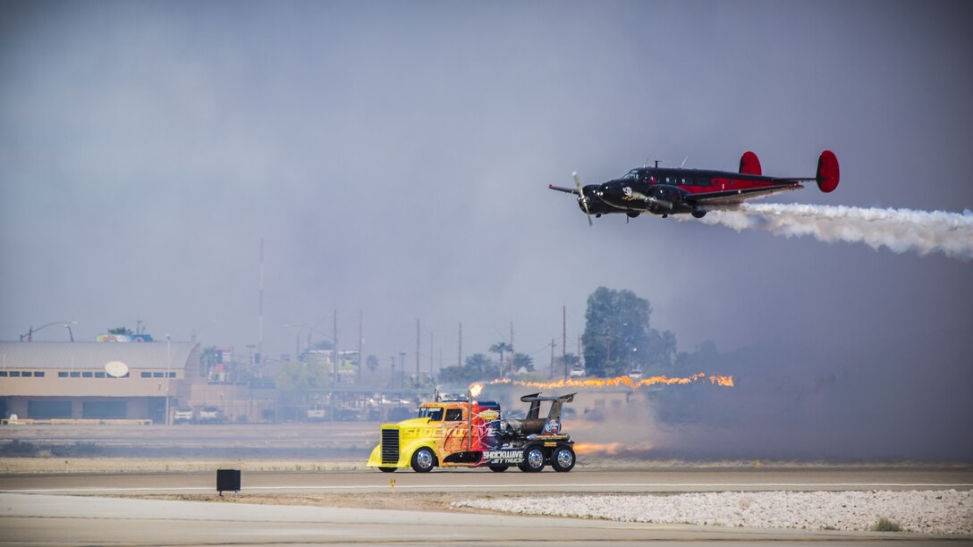 The Shockwave Jet Truck performs a high speed pass on the flightline with Matt Younkin's Twin Beech 18 during the 2017 Yuma Airshow at Marine Corps Air Station Yuma, Ariz., Saturday, March 18, 2017. (U.S Marine Corps Photo taken by Lance Cpl. George Melendez)
