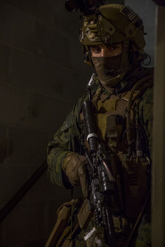 A Marine with 2nd Reconnaissance Battalion checks around a corner to ensure that there are no enemy forces with 2nd Reconnaissance Battalion a threat during a raid exercise as part of pre-deployment training at Fort Stewart, Ga., Dec. 6, 2017. Marines carried out the raid following their reconnaissance and surveillance exercises to emulate scenarios they may encounter with future operations. (U.S. Marine Corps photo by Lance Cpl. Taylor W. Cooper)