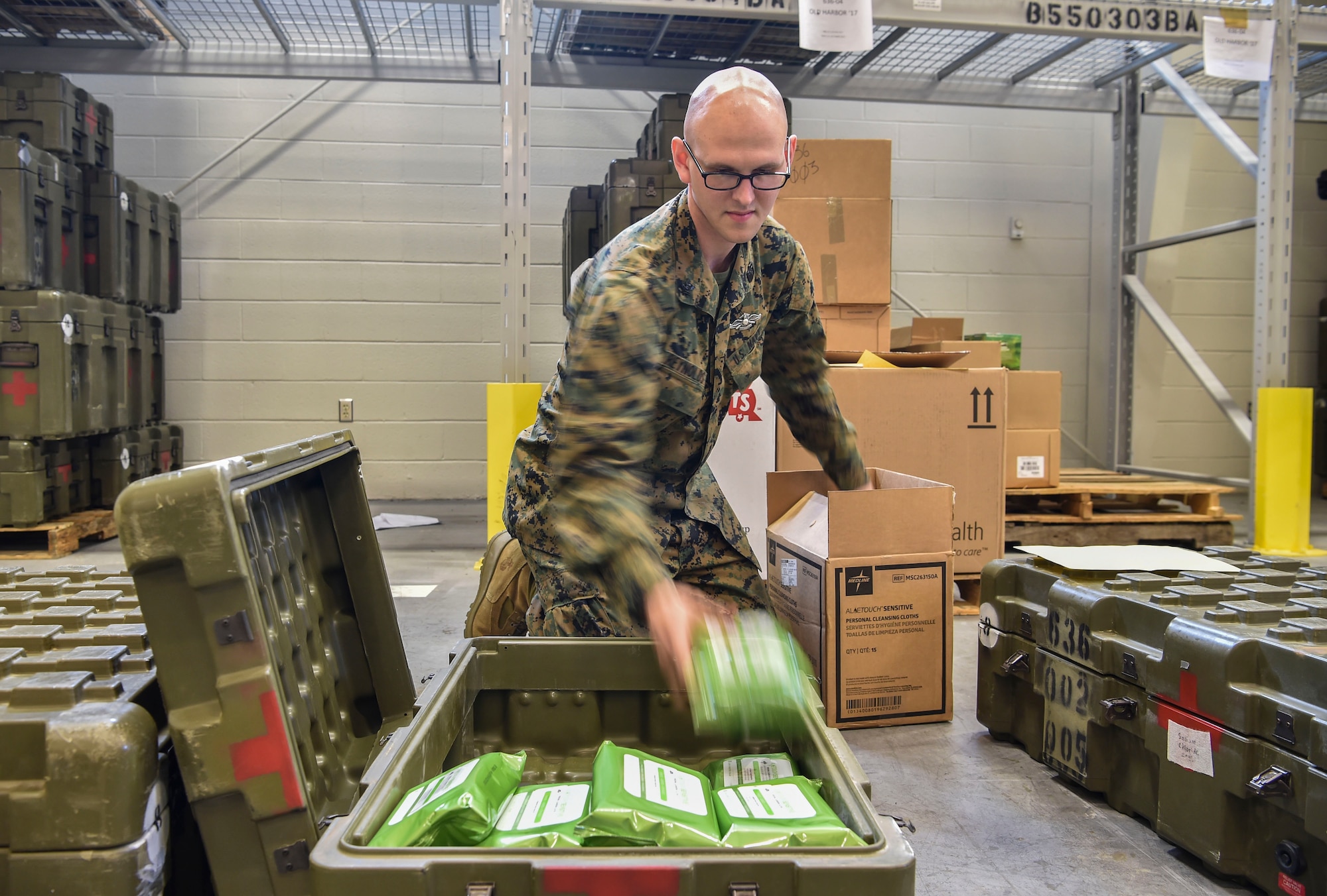 Hospitalman 2nd Class Kirby Reynolds, 4th Medical Logistics Company, packs a box with supplies at Joint Base Charleston, S.C., Dec. 18, 2017.