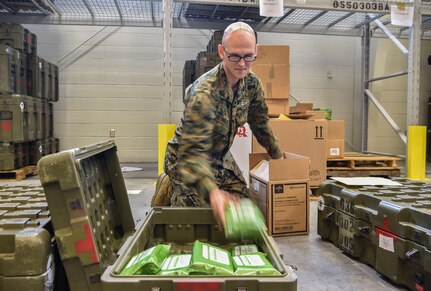 Hospitalman 2nd Class Kirby Reynolds, 4th Medical Logistics Company, packs a box with supplies at Joint Base Charleston, S.C., Dec. 18, 2017.