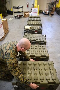 Hospitalman 2nd Class Kirby Reynolds, 4th Medical Logistics Company, packs a box with supplies at Joint Base Charleston, S.C., Dec. 18, 2017.