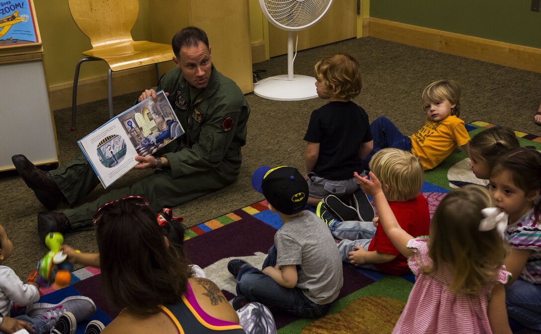 U.S. Marine Corps Maj. Benjamin D. Apple, the operations officer for Marine Fighter Training Squadron 401 (VMFT-401), stationed out of Marine Corps Air Station Yuma, Ariz., reads "Violet Pilot," an aviation-themed children's book to families at the main Yuma County Library, Wednesday, Feb. 15, 2017. (U.S. Marine Corps photo by Lance Cpl. Christian Cachola/Released)