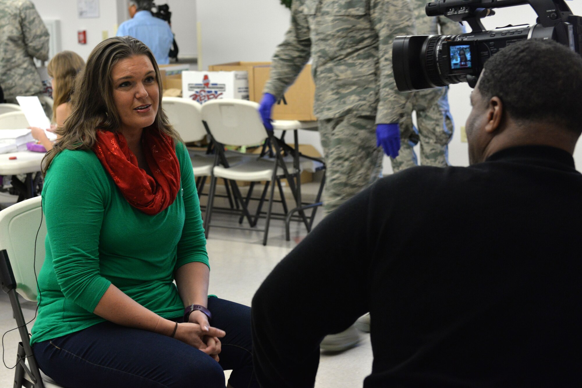 Elaine Sorrell, wife of Jeffery Sorrell, 17th Training Wing vice commander, is interviewed by Gary Jenkins, 17th Training Wing Public Affairs, at the Taylor Chapel on Goodfellow Air Force Base, Texas, Dec. 20, 2017. Mrs. Sorrell organized the cookie portion for the event. The program was established several years ago and has grown over the past two years.