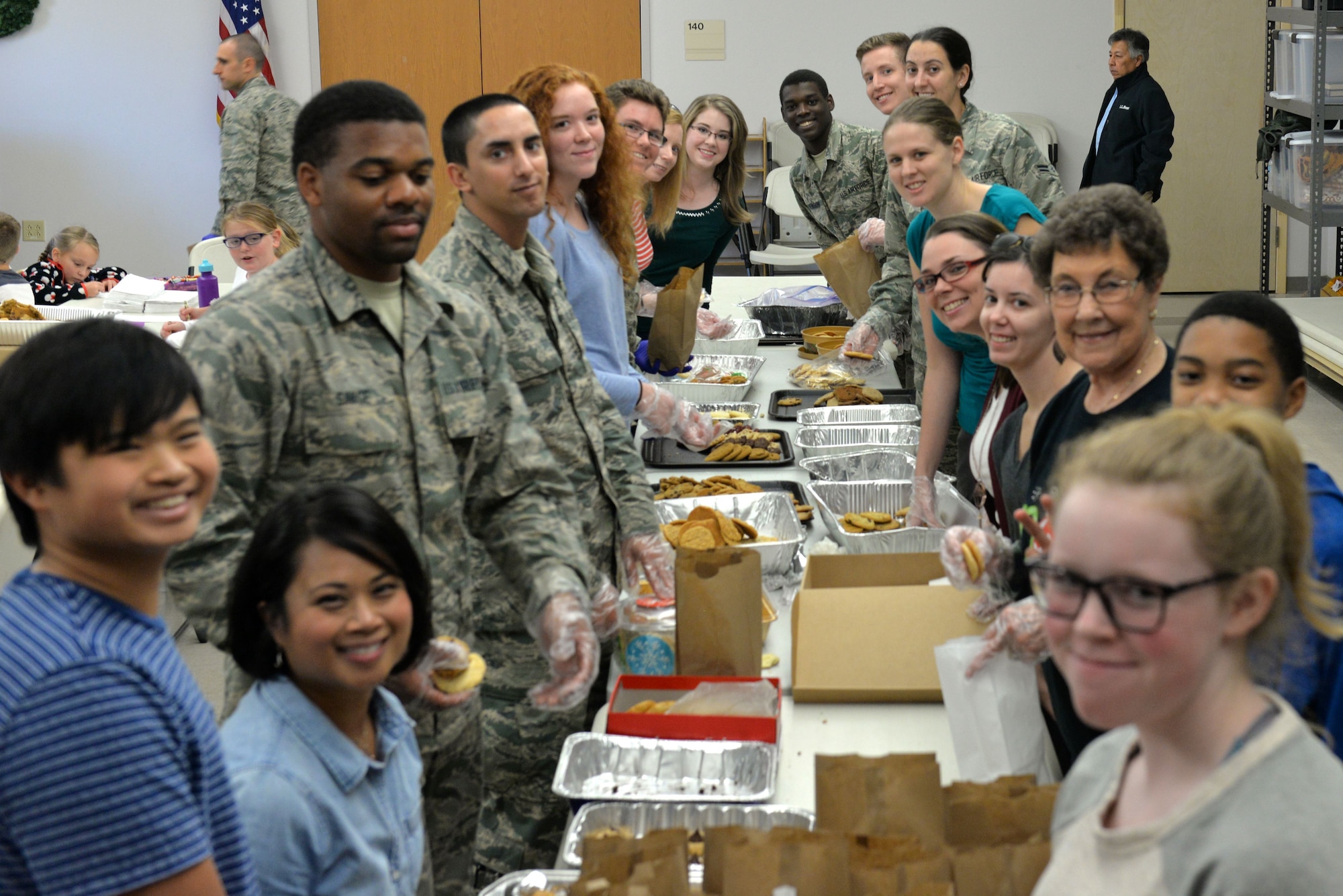 Volunteers prepare bags of cookies at the Taylor Chapel on Goodfellow Air Force Base, Texas, for distribution to Goodfellow trainees Dec. 20, 2017. The volunteers also prepared large cookie trays for various events and activities around the base for the next week.