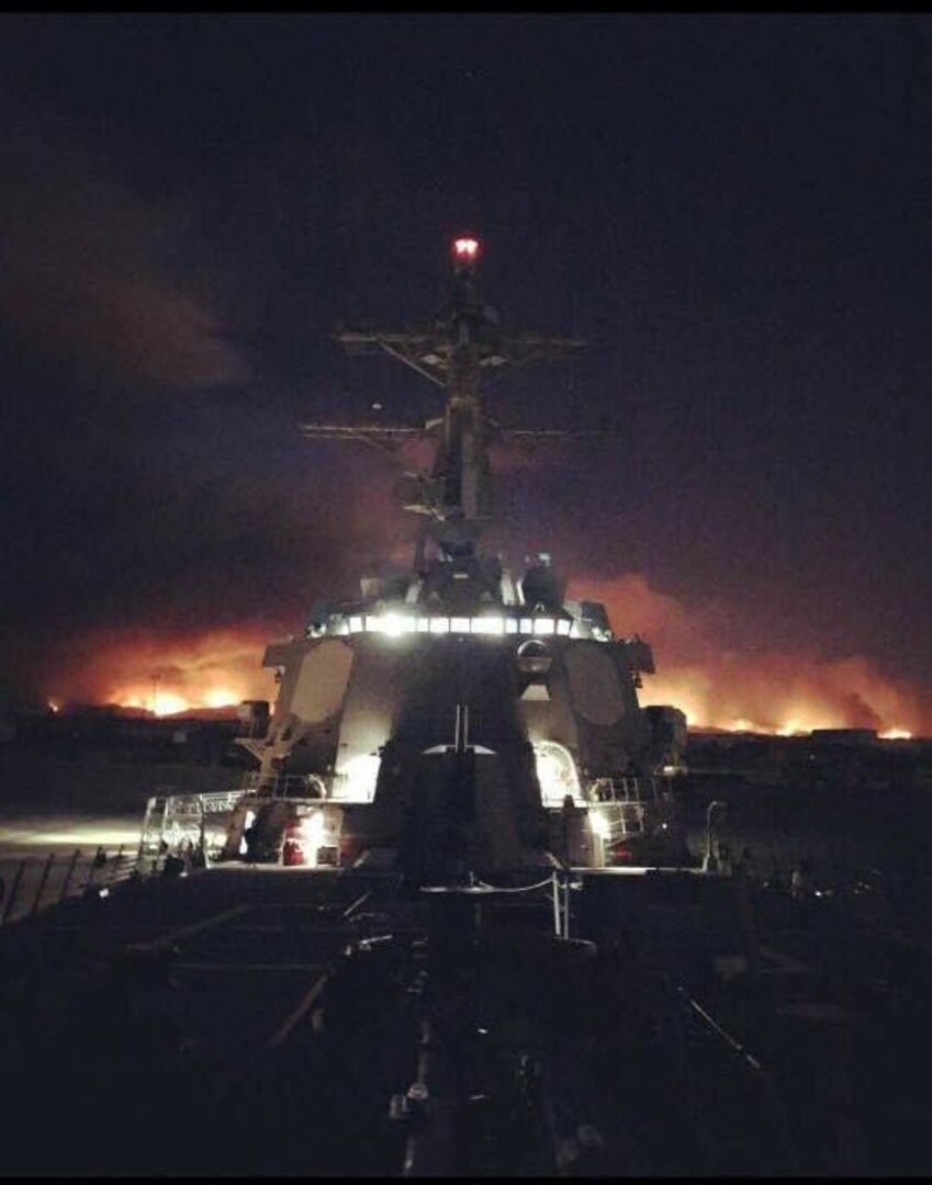 USS Sterett (DDG 104) moores in Port Hueneme as the Ventura County hills endure rampant fires, Dec. 5. The destroyer visited Naval Surface Warfare Center, Port Hueneme Division for a combat systems assessment and groom.