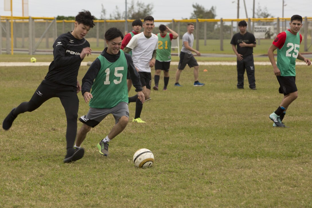 MCAS FUTENMA, OKINAWA, Japan— Two Kokusai University students compete for the ball during a soccer game Dec. 17 on Marine Corps Air Station Futenma, Okinawa, Japan.